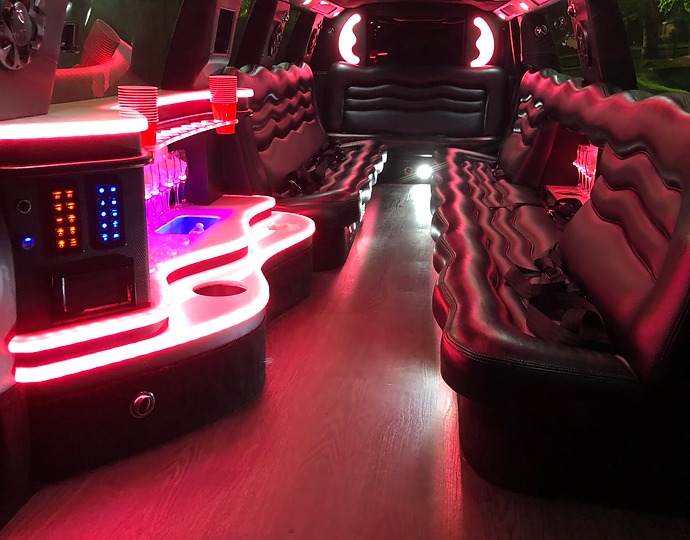 Interior of DC Limo Car 4U's luxury limousine featuring plush leather seats and a well-equipped bar for a comfortable ride.